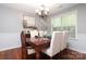 Formal dining room featuring elegant chandelier, wainscoting, and large window at 7515 Shadowstone Dr, Charlotte, NC 28270
