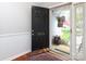 View of the front door, number 7515, a storm door and flowers from inside the front entrance at 7515 Shadowstone Dr, Charlotte, NC 28270