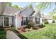 Charming single-story home with manicured lawn, flower beds, and an American flag at 7515 Shadowstone Dr, Charlotte, NC 28270