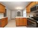 Well-lit kitchen boasts custom cabinets, white countertops, stainless steel appliances and an eat-in dining area at 7515 Shadowstone Dr, Charlotte, NC 28270