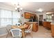 Bright eat-in dining area with views to the kitchen, featuring an island with bar seating at 7515 Shadowstone Dr, Charlotte, NC 28270