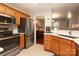 Well-equipped kitchen with stainless steel appliances, oak cabinets, and tile flooring at 7515 Shadowstone Dr, Charlotte, NC 28270