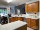 Bright kitchen features wood cabinets, white countertops, stainless steel appliances, and an open layout to the dining area at 7515 Shadowstone Dr, Charlotte, NC 28270