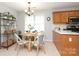Bright kitchen with an adjacent dining nook, featuring a round table and decoratively appointed shelving at 7515 Shadowstone Dr, Charlotte, NC 28270