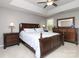 Spacious main bedroom with tray ceilings, fan, and traditional furniture at 7515 Shadowstone Dr, Charlotte, NC 28270