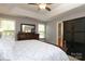Spacious main bedroom with tray ceilings, fan, and traditional furniture at 7515 Shadowstone Dr, Charlotte, NC 28270