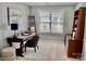 Well-lit home office with dark wood furniture, a bright window and neutral carpeting at 7515 Shadowstone Dr, Charlotte, NC 28270