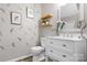 Stylish half bathroom with modern fixtures, decorative artwork, and a clean design at 7910 Camden Hollow Rd, Huntersville, NC 28078