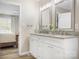 This bathroom boasts a double vanity with granite countertops, modern fixtures, and a view into the bedroom at 7910 Camden Hollow Rd, Huntersville, NC 28078
