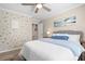 A stylish bedroom with a heart-themed accent wall, a cozy bed, and wood flooring at 7910 Camden Hollow Rd, Huntersville, NC 28078