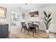 Charming dining area featuring a wooden table, black chairs, and modern artwork at 7910 Camden Hollow Rd, Huntersville, NC 28078