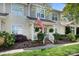Charming two-story townhouse with a inviting porch and an American flag at 7910 Camden Hollow Rd, Huntersville, NC 28078