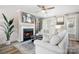 Cozy living room with a fireplace, plush seating, and ample natural light at 7910 Camden Hollow Rd, Huntersville, NC 28078