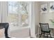 A well-lit, cozy corner with a window, a work desk, and a comfortable leather chair at 7910 Camden Hollow Rd, Huntersville, NC 28078