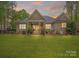 Large, green backyard with a covered patio, ample seating, and lush landscaping at 7982 Buena Vista Dr, Denver, NC 28037