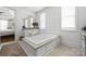 Bright bathroom featuring a large soaking tub and vanity next to bedroom at 7982 Buena Vista Dr, Denver, NC 28037