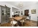 Cozy dining room with stylish furnishings, featuring a large wooden table and hardwood floors, adjoining the living area at 7982 Buena Vista Dr, Denver, NC 28037