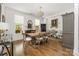 Bright dining room with a large wooden table, decorative chandelier, hardwood floors, and elegant furnishings at 7982 Buena Vista Dr, Denver, NC 28037