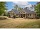 Beautiful brick home featuring mature landscaping, a covered porch, and classic architectural details at 7982 Buena Vista Dr, Denver, NC 28037