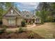 Charming brick home with well-manicured landscaping, walkway, covered porch, and classic architectural details at 7982 Buena Vista Dr, Denver, NC 28037