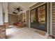 Cozy front porch with brick accents, ceiling fans, rocking chairs, and a welcoming double door entrance at 7982 Buena Vista Dr, Denver, NC 28037