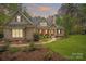 Charming brick home with a well-manicured lawn and inviting walkway at sunset at 7982 Buena Vista Dr, Denver, NC 28037
