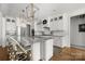 Bright, modern kitchen with white cabinets, stainless steel appliances, and granite island with bar seating at 7982 Buena Vista Dr, Denver, NC 28037