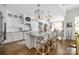 Gourmet kitchen with white cabinetry, large island with seating, granite countertops, and pendant lighting at 7982 Buena Vista Dr, Denver, NC 28037