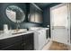 Well-lit laundry room with a modern sink, storage cabinets, and white washer/dryer units at 7982 Buena Vista Dr, Denver, NC 28037