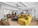Open-concept living room flows into kitchen, featuring stylish furniture, coffered ceiling, and hardwood floors at 7982 Buena Vista Dr, Denver, NC 28037