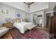 Spacious bedroom with hardwood floors, natural light, ensuite bathroom access, and stylish decor for a relaxing retreat at 7982 Buena Vista Dr, Denver, NC 28037