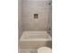 Renovated bathroom featuring a tile shower with a built-in shelf at 925 14Th St, Lancaster, SC 29720