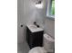 Updated bathroom vanity featuring a dark wood cabinet, light countertop, and brushed nickel fixtures at 925 14Th St, Lancaster, SC 29720