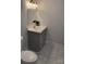 Modern bathroom featuring tiled floors, a vanity with a gray cabinet, and a mirror at 925 14Th St, Lancaster, SC 29720
