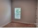 Cozy bedroom with neutral walls, carpet, and a window with natural light at 925 14Th St, Lancaster, SC 29720