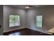 Bright living room featuring hardwood floors, a ceiling fan, and natural light from two windows at 925 14Th St, Lancaster, SC 29720