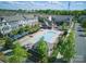 Aerial view showcasing a community pool with lounge chairs and multiple townhome buildings at 9914 Ainslie Downs St, Charlotte, NC 28273