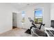 Well-lit bedroom with a sleek exercise bike, modern decor, and a sunlit window at 9914 Ainslie Downs St, Charlotte, NC 28273
