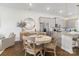 Inviting dining area featuring a round table, decorative mirror, and a view into the modern kitchen at 9914 Ainslie Downs St, Charlotte, NC 28273