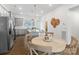 Bright dining area boasts a modern table setting next to a spacious kitchen with stainless steel appliances at 9914 Ainslie Downs St, Charlotte, NC 28273