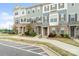 Exterior view showing townhomes with stone accents, various colored siding, and manicured landscaping at 9914 Ainslie Downs St, Charlotte, NC 28273
