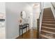 Inviting foyer with hardwood floors, staircase, decor, and views into adjacent office space at 9914 Ainslie Downs St, Charlotte, NC 28273