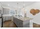 Modern kitchen features gray cabinets, granite countertops, and stainless steel appliances at 9914 Ainslie Downs St, Charlotte, NC 28273
