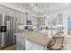 Well-lit kitchen with granite countertops, stainless steel appliances, and a stylish breakfast bar at 9914 Ainslie Downs St, Charlotte, NC 28273