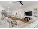 Spacious living room featuring hardwood floors, a fireplace, an open floor plan, and a modern kitchen at 9914 Ainslie Downs St, Charlotte, NC 28273