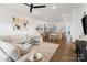 Open-concept living room and kitchen with hardwood floors and ample natural light at 9914 Ainslie Downs St, Charlotte, NC 28273