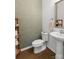 Elegant powder room showcasing a pedestal sink, decorative mirror, and neutral color palette at 9914 Ainslie Downs St, Charlotte, NC 28273