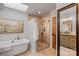 Bright bathroom with a soaking tub and a tiled walk-in shower with glass doors at 10315 Washam Potts Rd, Cornelius, NC 28031