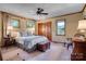 Bedroom with a ceiling fan, hardwood trimmed windows, and a decorative trunk at 10315 Washam Potts Rd, Cornelius, NC 28031