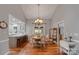 Charming dining area with a chandelier, hardwood floors, and adjacent breakfast bar at 10315 Washam Potts Rd, Cornelius, NC 28031